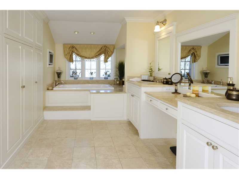 17 Copper Beech Road Greenwich, CT 06830 - Photo 12 of 16 a bathroom with a sink mirror and a bathtub