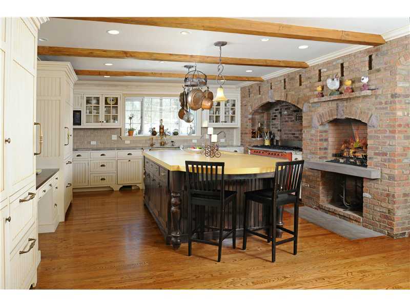 17 Copper Beech Road Greenwich, CT 06830 - Photo 6 of 16 a dining hall with stainless steel appliances kitchen island granite countertop a table chairs and a wooden floor