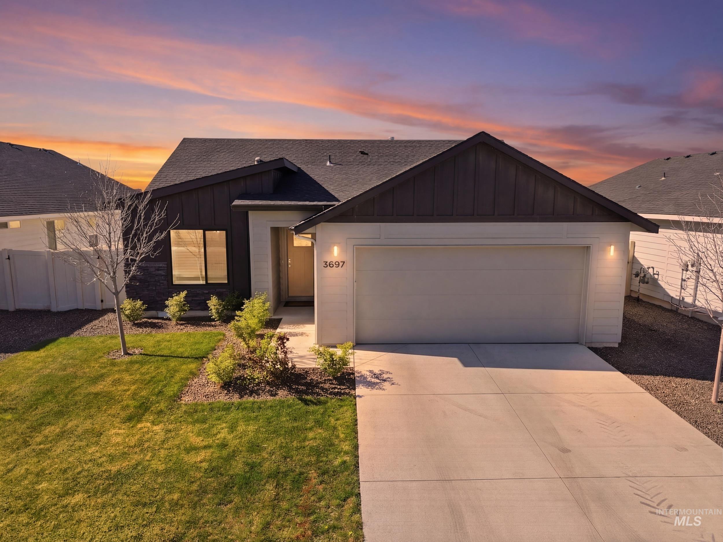 3697 W Lane Meridian, ID 83642 - Photo 1 of 44 View of front of house featuring board and batten siding, a shingled roof, an attached garage, and driveway