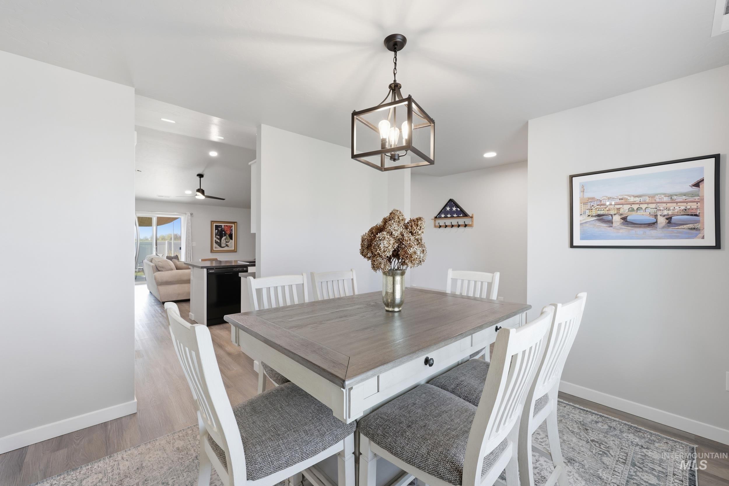 3697 W Lane Meridian, ID 83642 - Photo 11 of 44 Dining space with light wood-style floors, a ceiling fan, and suspended lighting