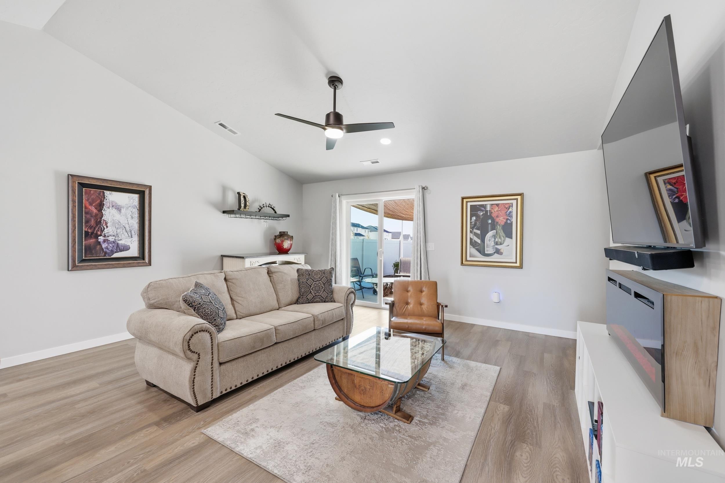 3697 W Lane Meridian, ID 83642 - Photo 17 of 44 Living room featuring a ceiling fan, LVP Flooring and lofted ceiling