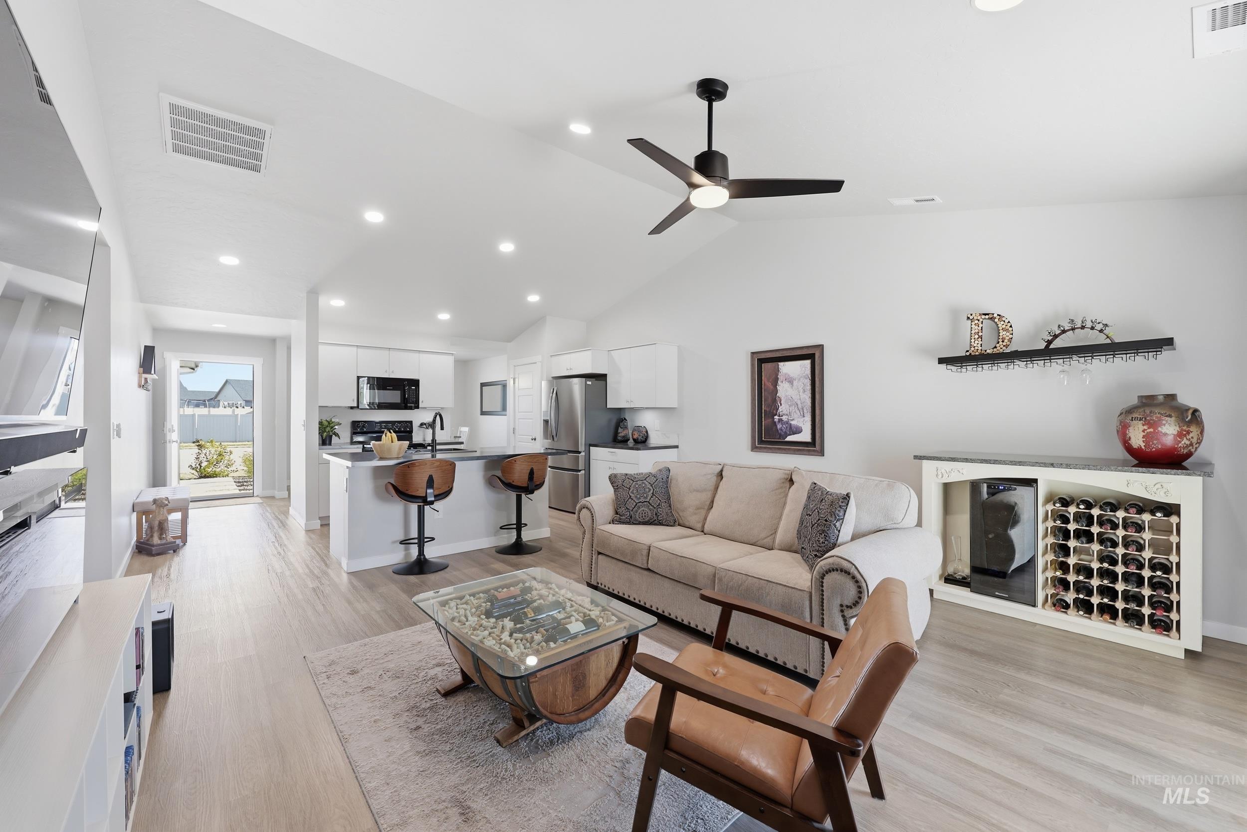 3697 W Lane Meridian, ID 83642 - Photo 19 of 44 Living area with recessed lighting, ceiling fan, LVP Fooring, and lofted ceiling