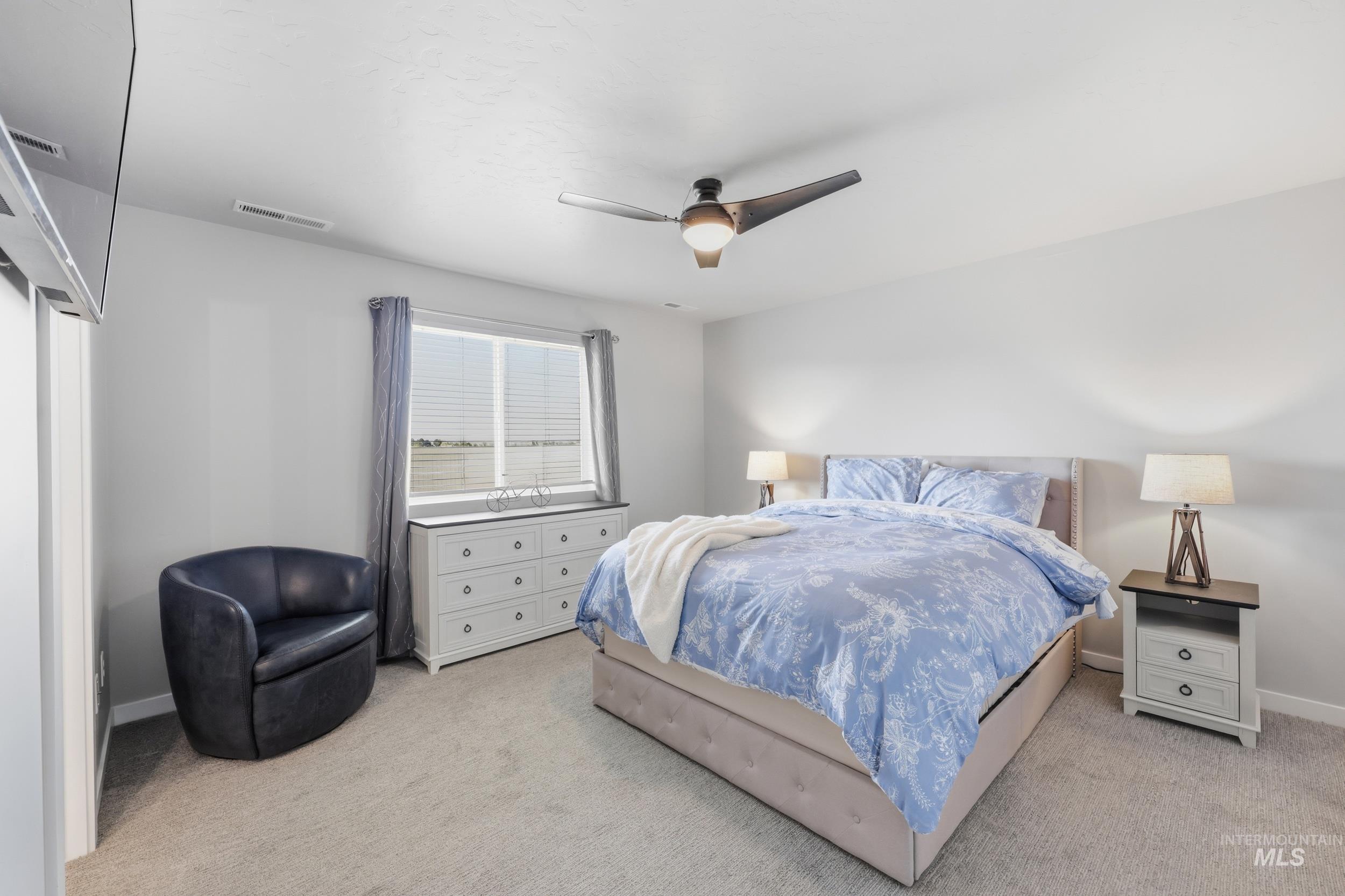 3697 W Lane Meridian, ID 83642 - Photo 24 of 44 Bedroom with ceiling fan and light colored carpet