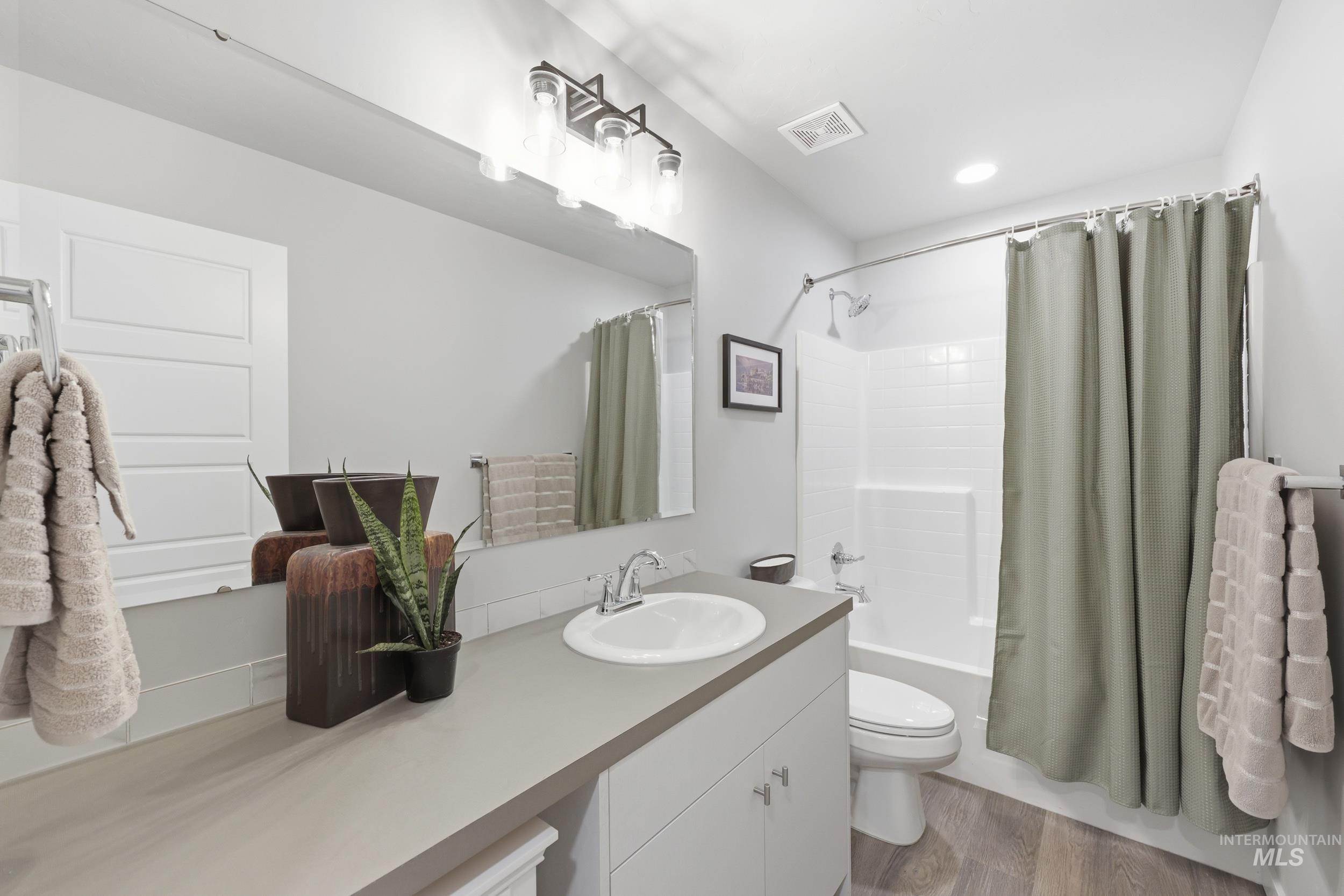 3697 W Lane Meridian, ID 83642 - Photo 28 of 44 Bathroom featuring vanity, shower / tub combo with curtain, lvp flooring