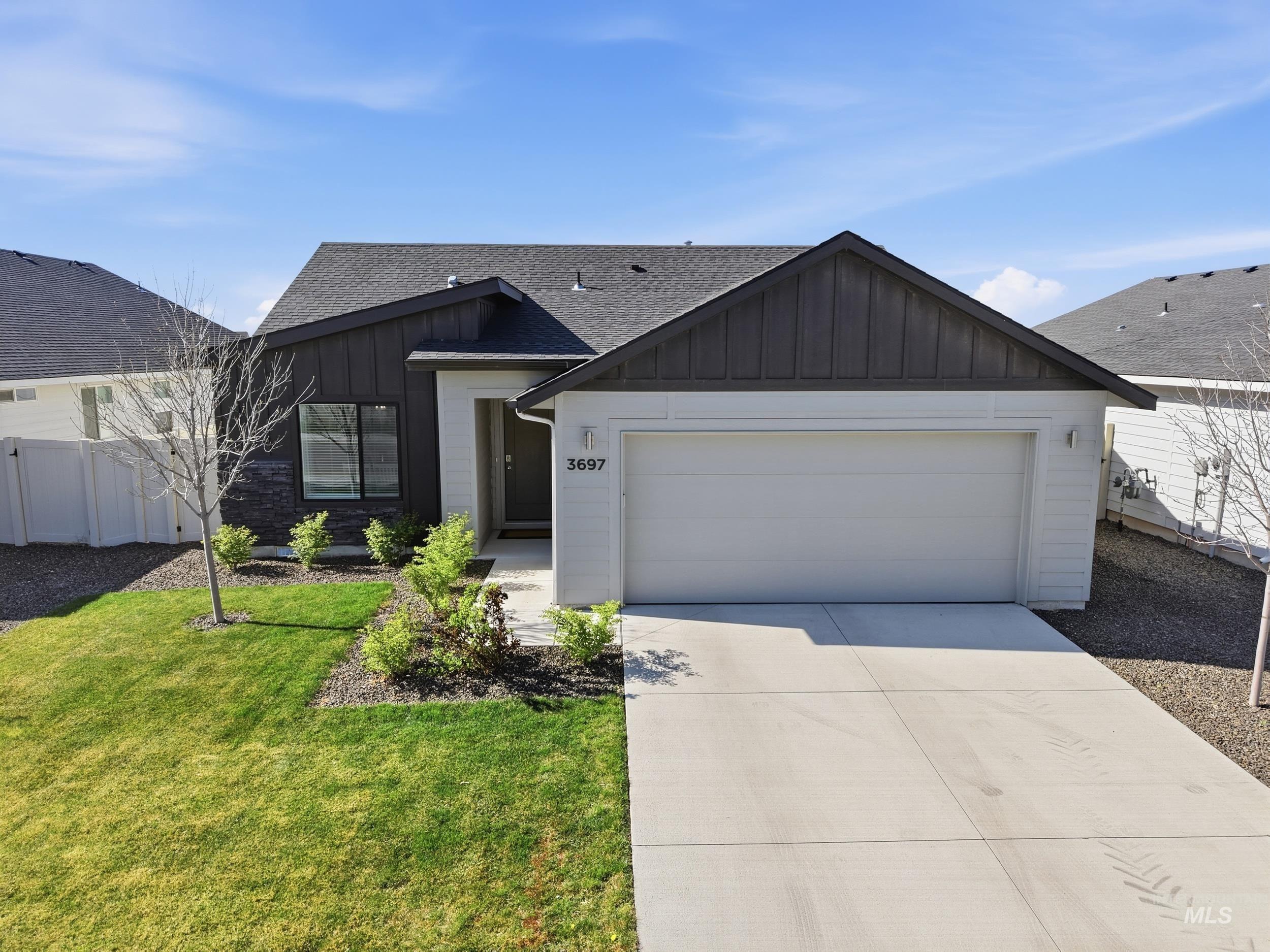 3697 W Lane Meridian, ID 83642 - Photo 3 of 44 View of front facade with board and batten siding, a shingled roof, driveway, and an attached garage