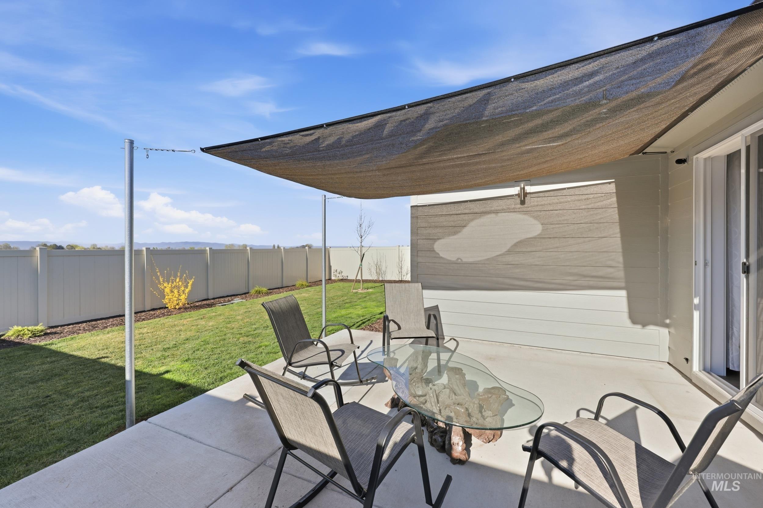3697 W Lane Meridian, ID 83642 - Photo 34 of 44 Fenced backyard featuring a patio area and outdoor dining area. Shade sail.