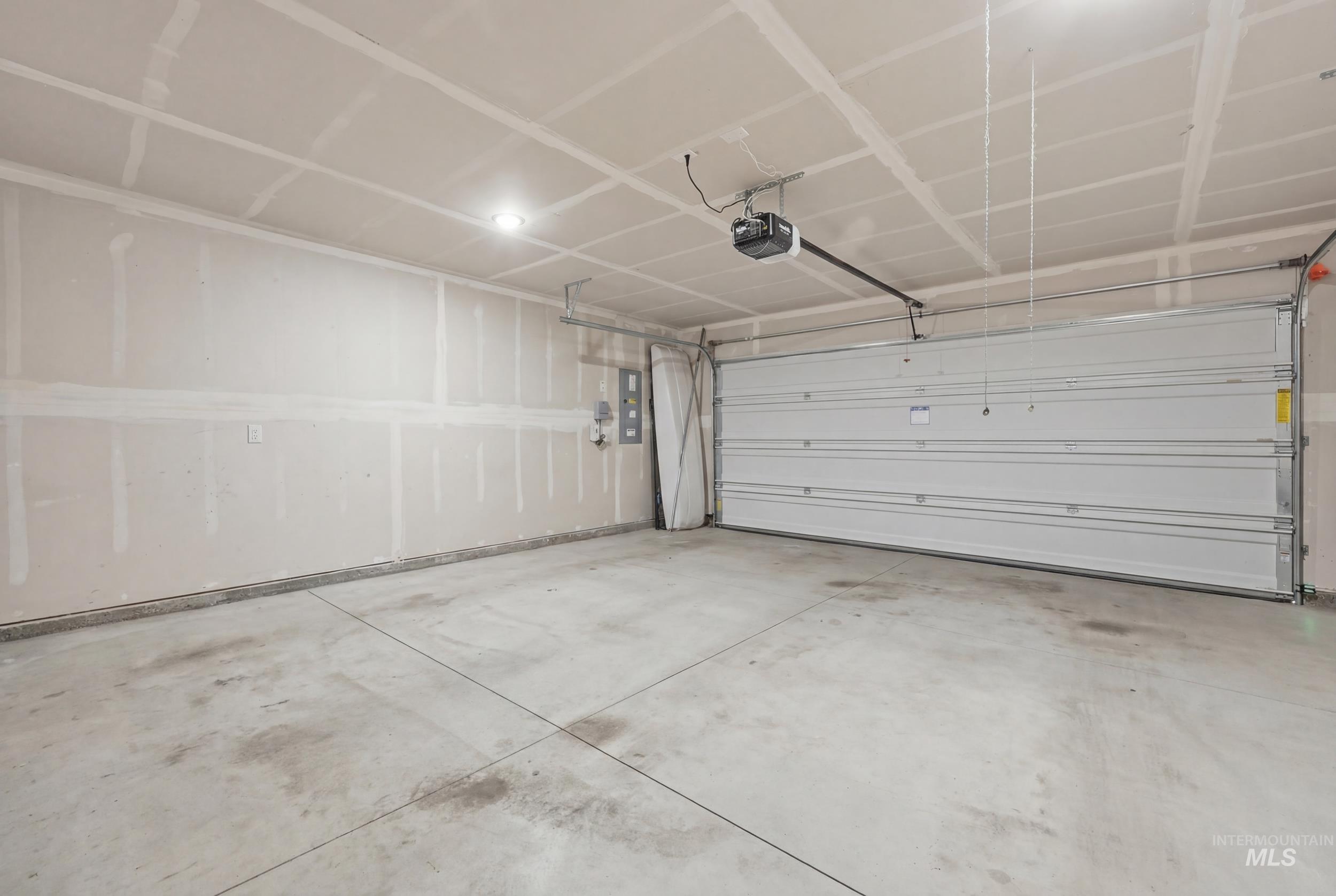 3697 W Lane Meridian, ID 83642 - Photo 37 of 44 Garage featuring electric panel and a garage door opener. Already wired and has EV charging plug!