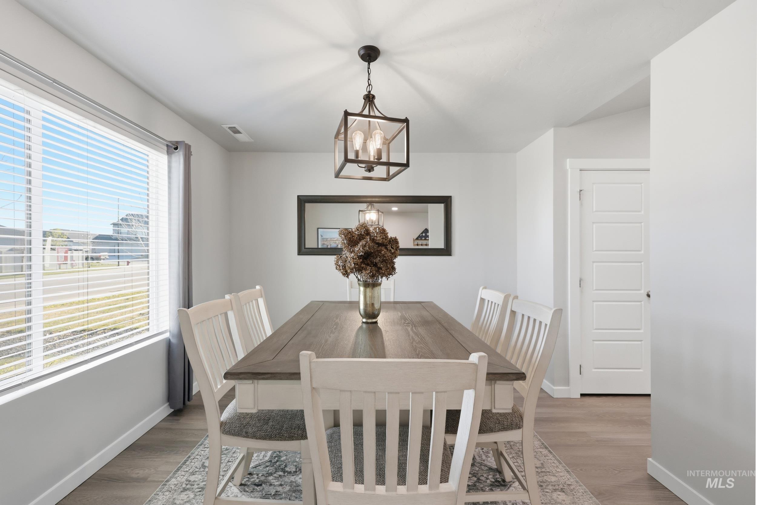 3697 W Lane Meridian, ID 83642 - Photo 9 of 44 Dining room with wood finished floors and hanging lights
