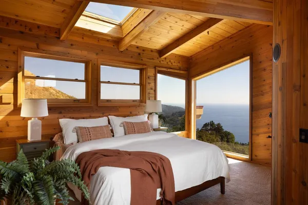 a bedroom with a bed and a large window