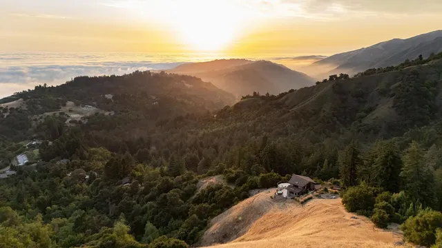 a view of a mountain range with a lush green hillside