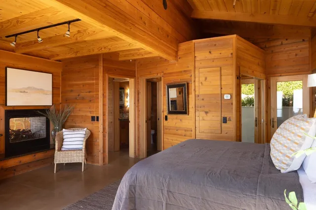 a bedroom with a bed and a mirror