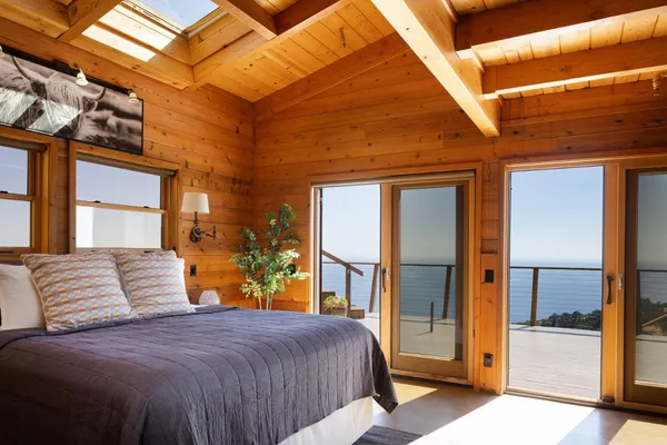 a bedroom with a large bed and a large window