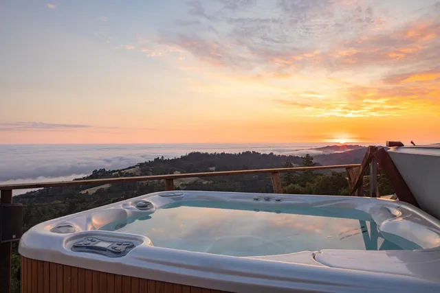 a view of roof with furniture and city view