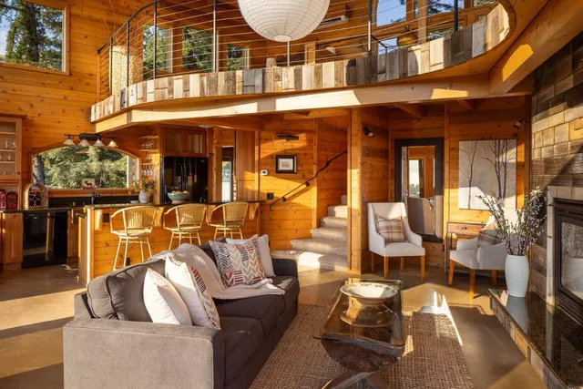 a view of a patio with couches chairs and wooden floor