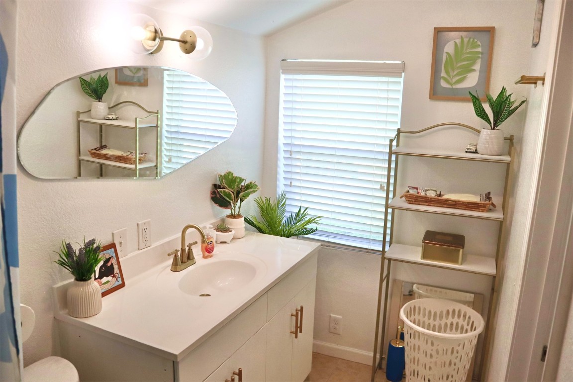 1007 Johnson Street Lockhart, TX 78644 - Photo 6 of 15 a bathroom with a sink and a mirror
