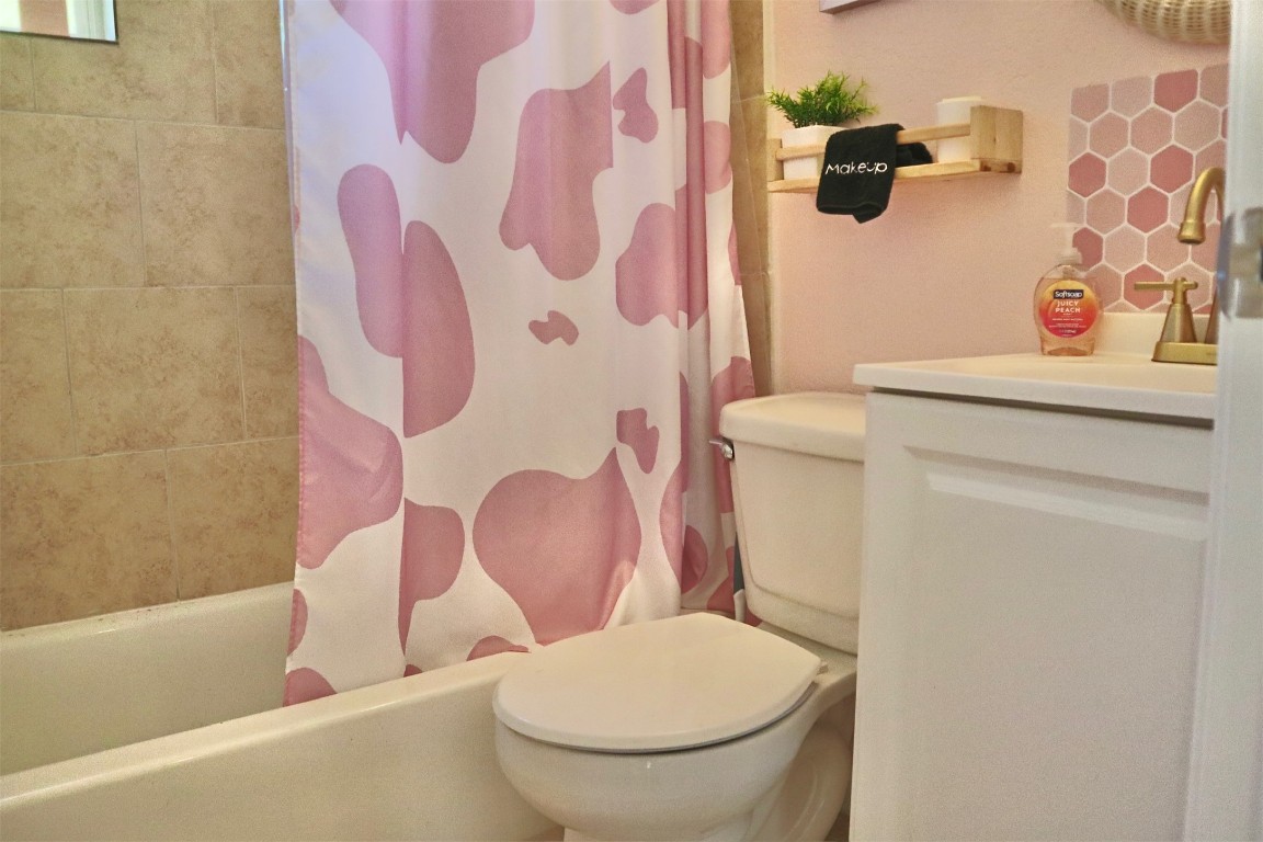1007 Johnson Street Lockhart, TX 78644 - Photo 7 of 15 a white toilet sitting next to a bath tub