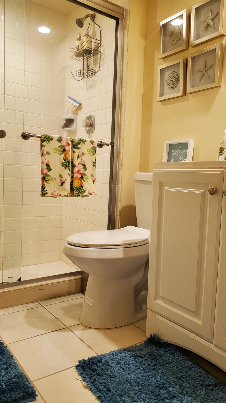 2116 21st Lane, Unit 2116 Greenacres, FL 33463 - Photo 11 of 14 a bathroom with a toilet and a shower