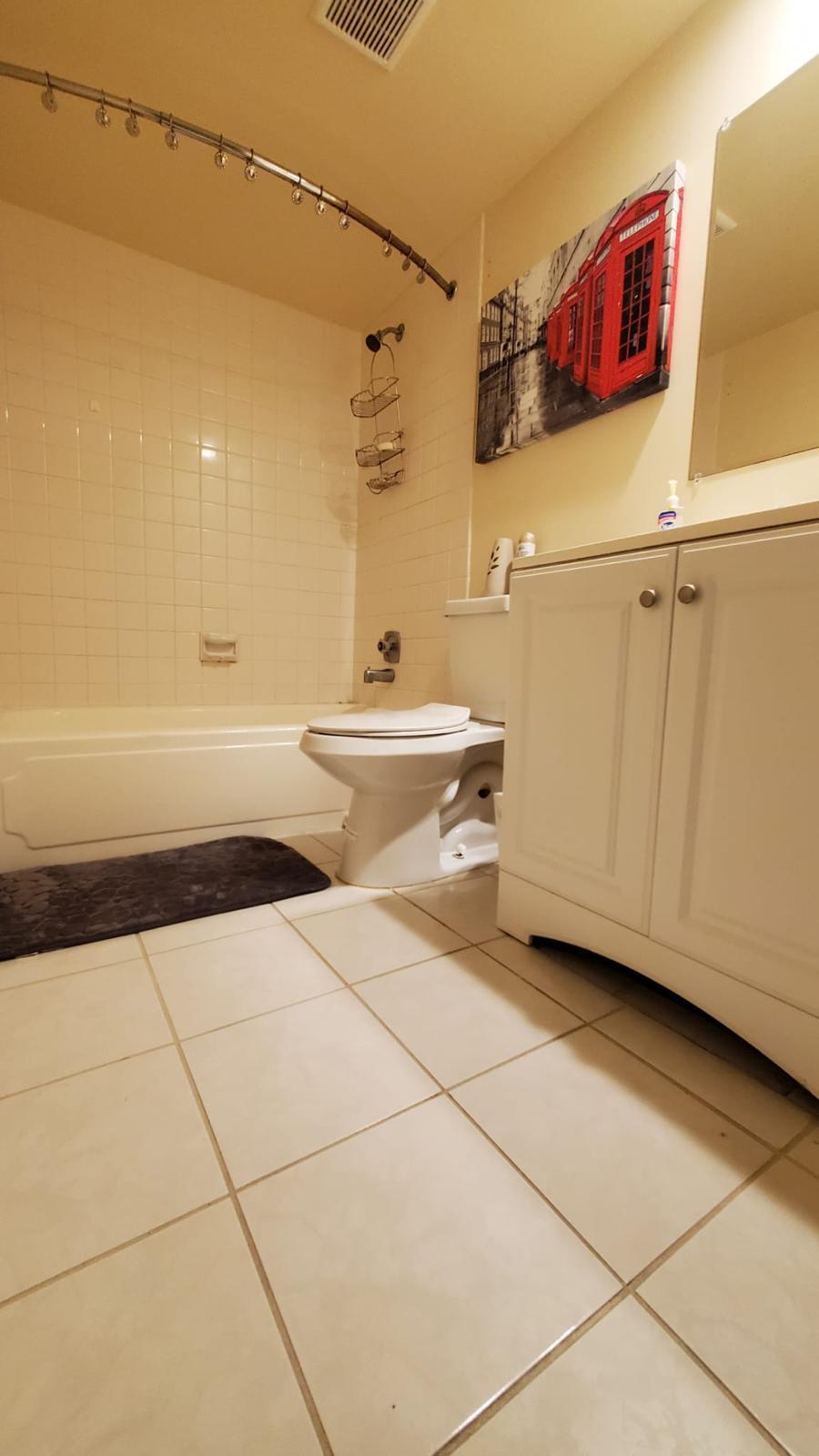 2116 21st Lane, Unit 2116 Greenacres, FL 33463 - Photo 7 of 14 a bathroom with a sink and a vanity