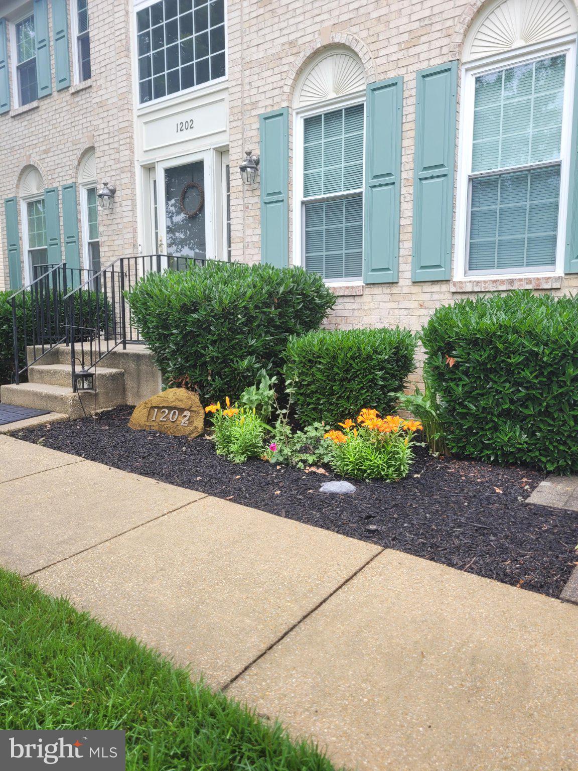 1202 Strausberg Street Accokeek, MD 20607 - Photo 8 of 43 Charming entrance with vibrant blooms.