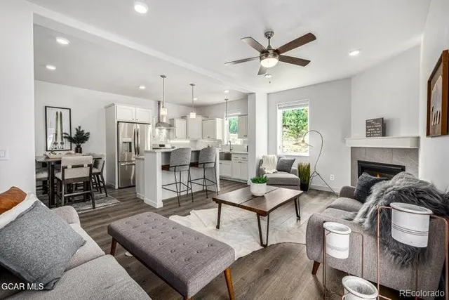 a living room with furniture and kitchen view