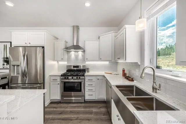 a kitchen with a sink stove and refrigerator