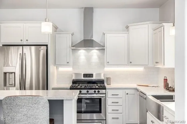 a kitchen with cabinets appliances and a window