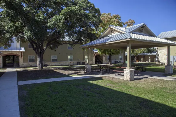 a view of a house with backyard porch and sitting area
