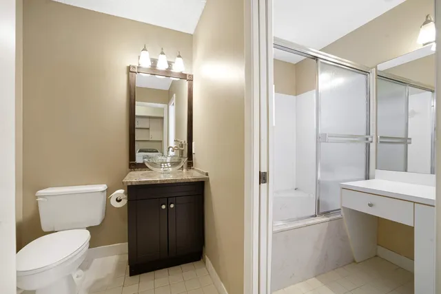 a bathroom with a toilet a sink and a mirror