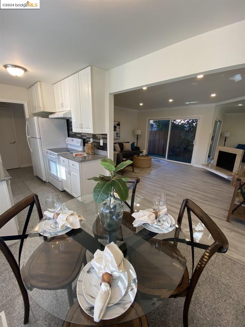 a living room with furniture and kitchen view