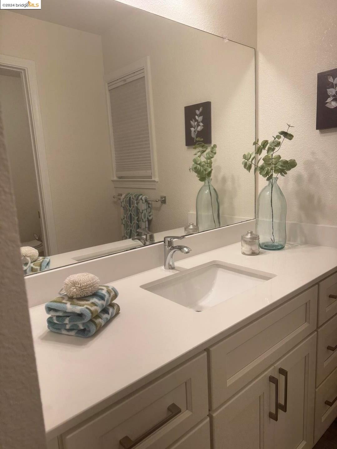 2548 Jones Road, Unit 10 Walnut Creek, CA 94597 - Photo 9 of 10 a bathroom with a sink and a mirror