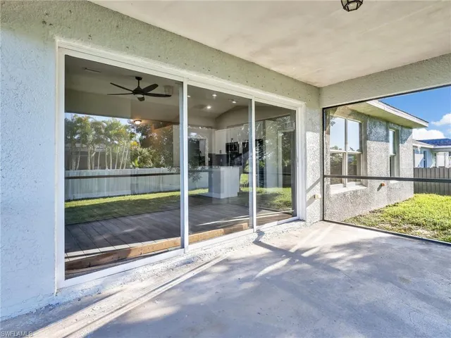 a view of an empty room with a floor to ceiling window and an outdoor view