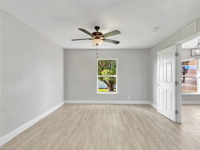 wooden floor in an empty room with a window