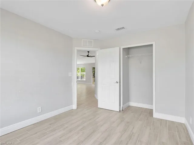 a view of an empty room and wooden floor