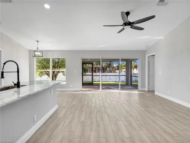 a view of a kitchen with a sink and a window