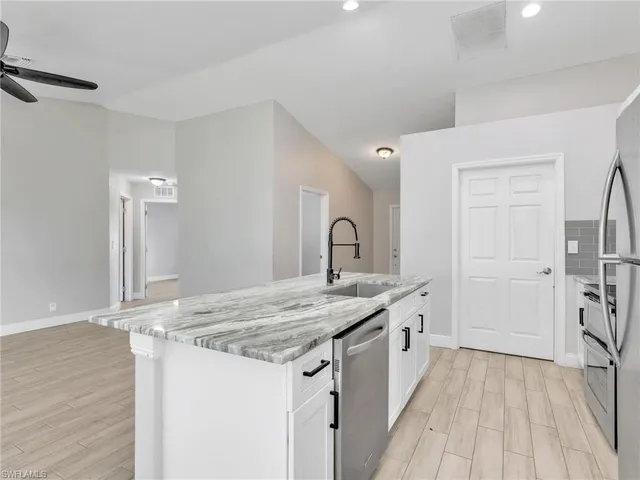 a kitchen with a sink stove and refrigerator
