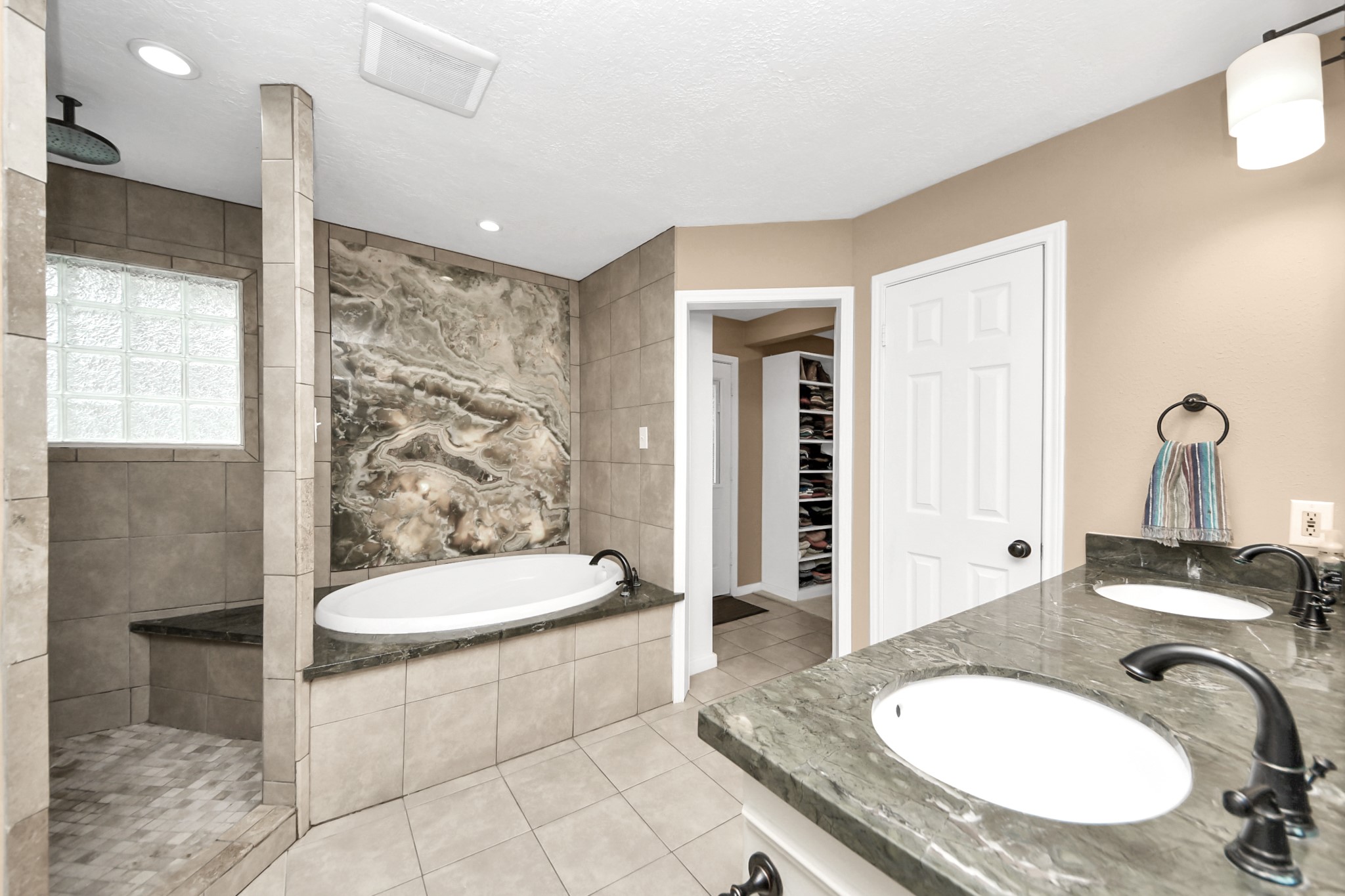 6403 Craigway Road Spring, TX 77389 - Photo 14 of 39 Primary bath with backlit onyx tub, walk in shower, and dual vanity