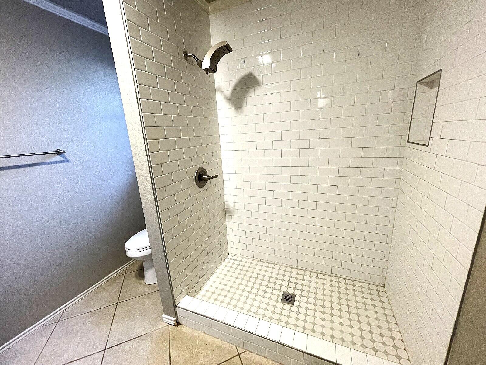 6328 10th Street Lubbock, TX 79416 - Photo 11 of 25 a bathroom with a shower