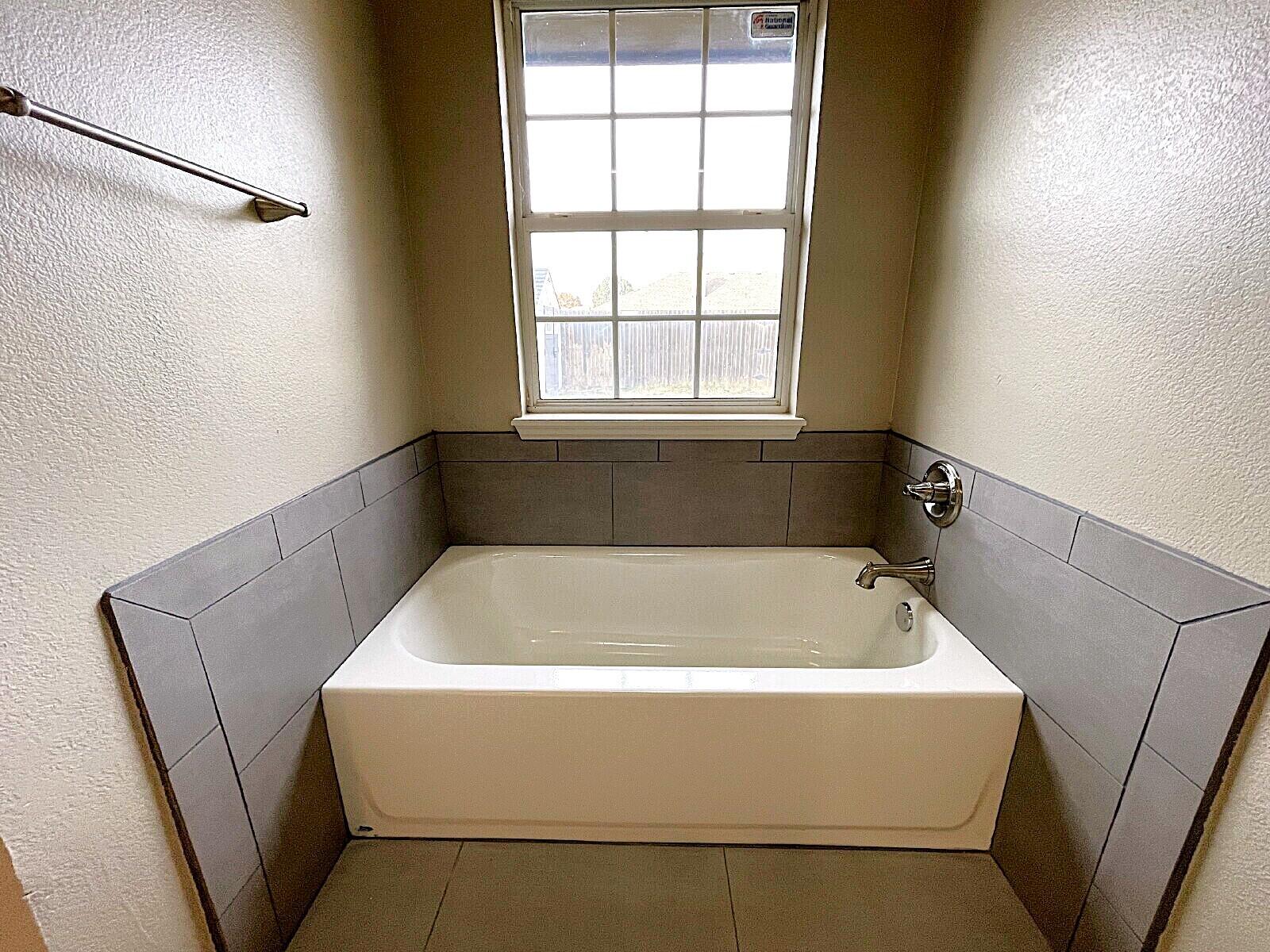 6328 10th Street Lubbock, TX 79416 - Photo 20 of 25 a bathroom with a bathtub