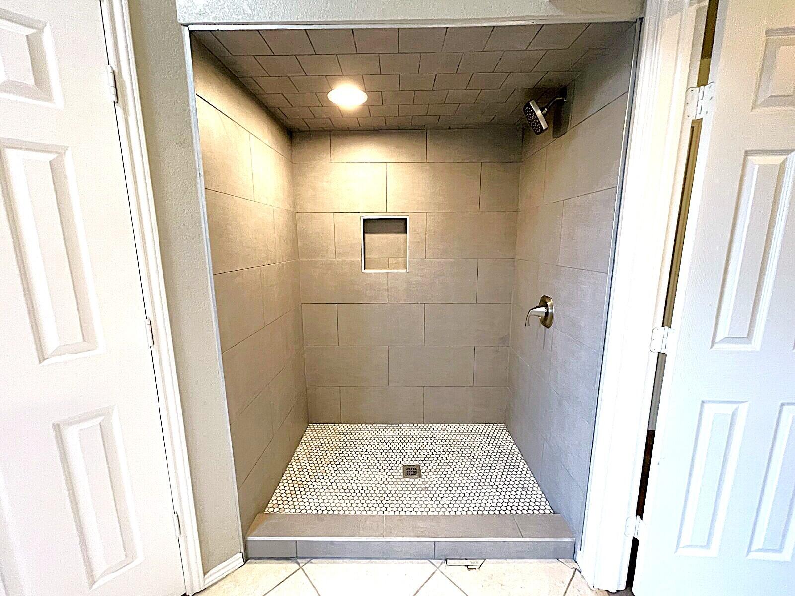 6328 10th Street Lubbock, TX 79416 - Photo 21 of 25 a bathroom with a shower