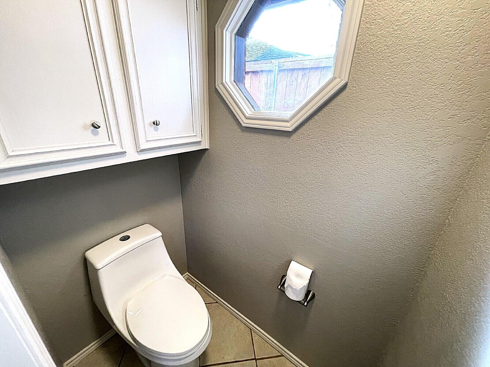 6328 10th Street Lubbock, TX 79416 - Photo 22 of 25 a bathroom with a toilet and a sink