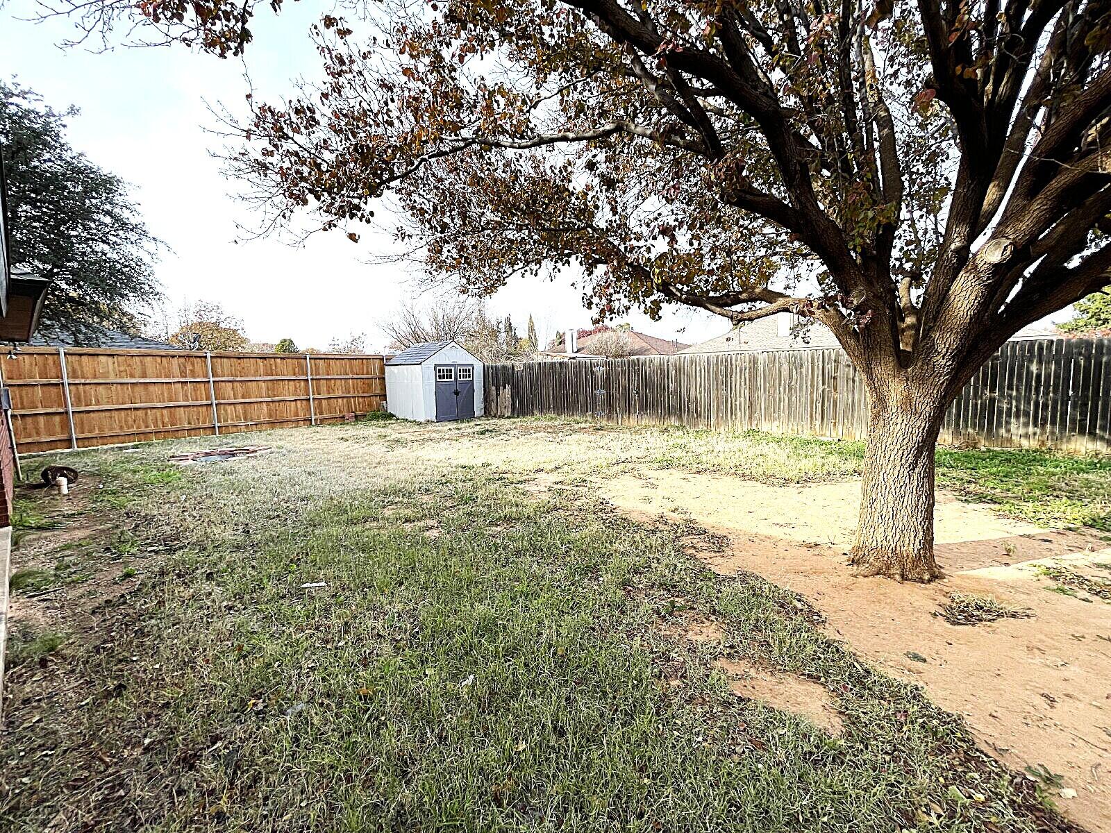 6328 10th Street Lubbock, TX 79416 - Photo 23 of 25 a view of a yard with wooden fence