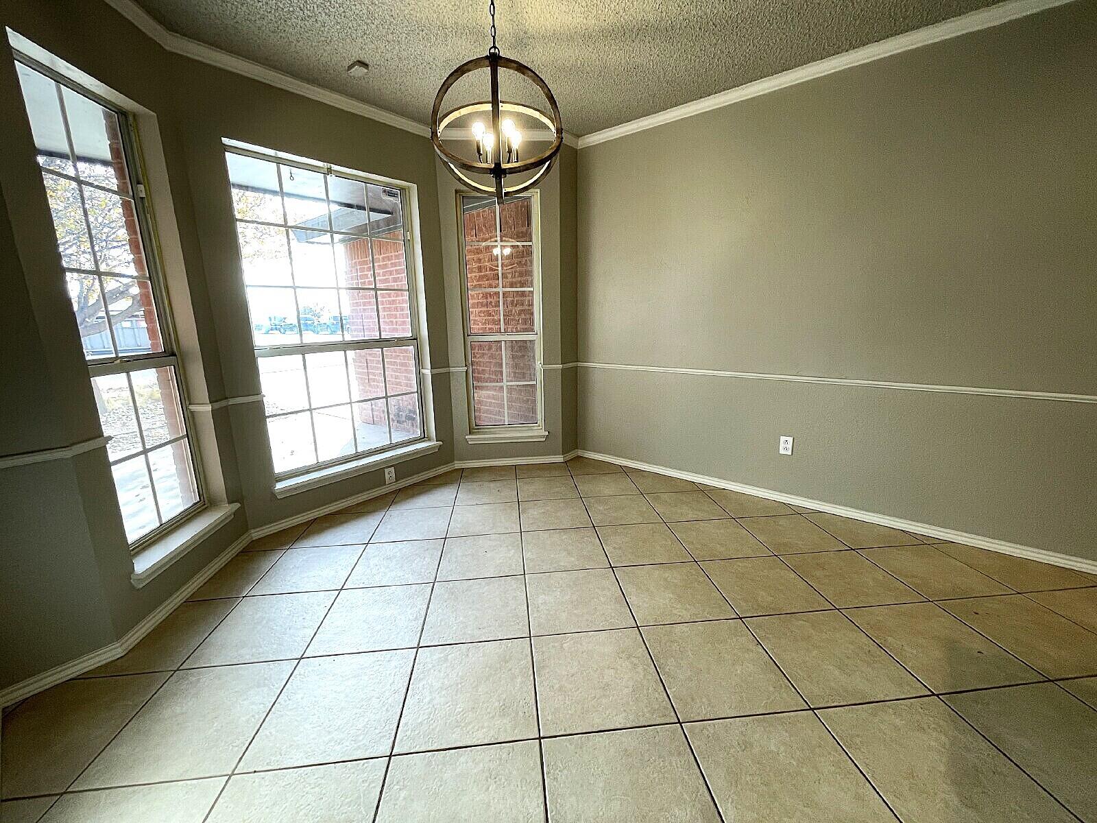 6328 10th Street Lubbock, TX 79416 - Photo 3 of 25 a view of an empty room with a window