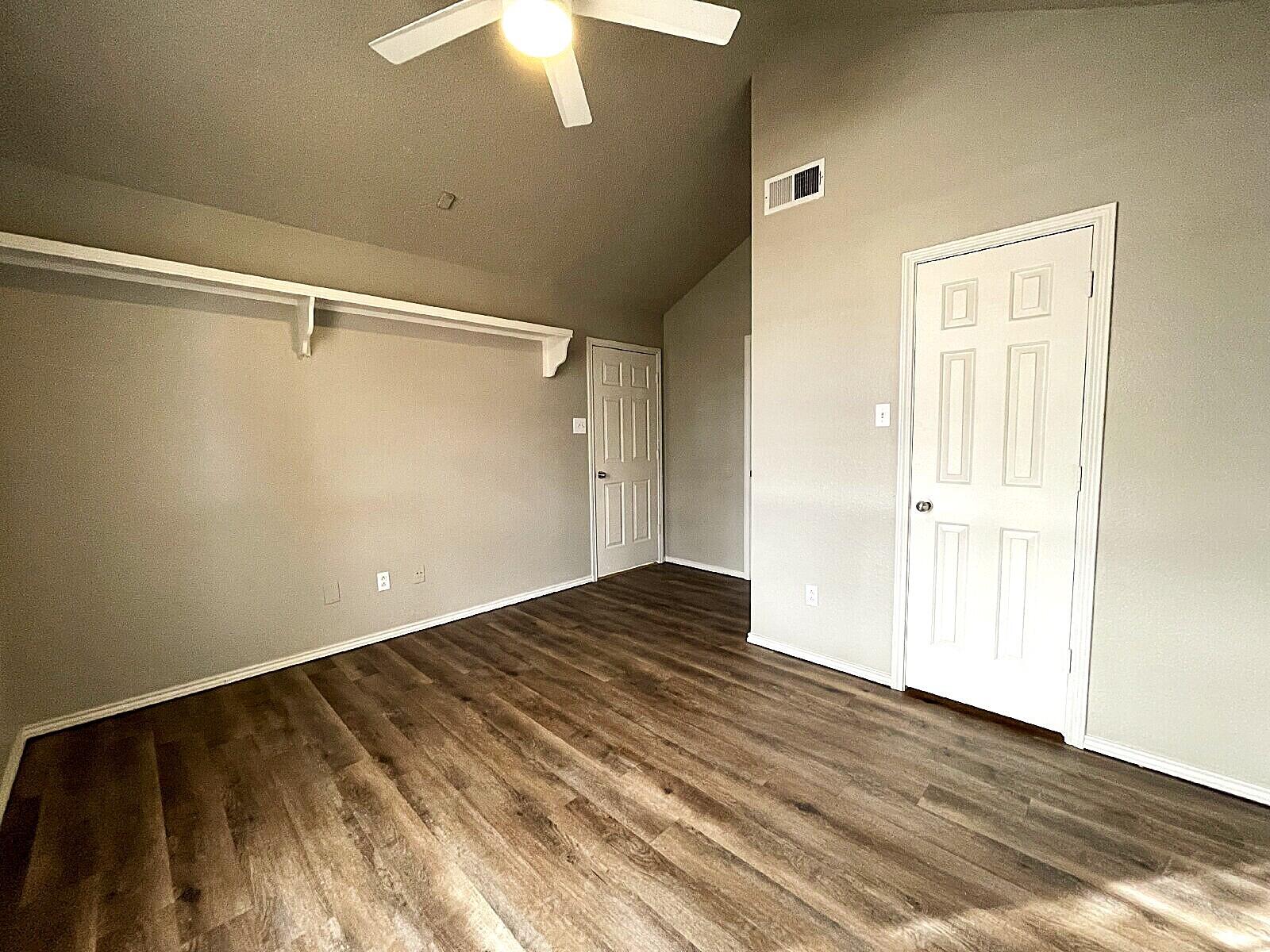 6328 10th Street Lubbock, TX 79416 - Photo 9 of 25 wooden floor in an empty room