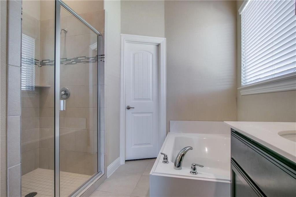 552 Winnetka Drive Oak Point, TX 75068 - Photo 25 of 40 a bathroom with a bathtub and a sink