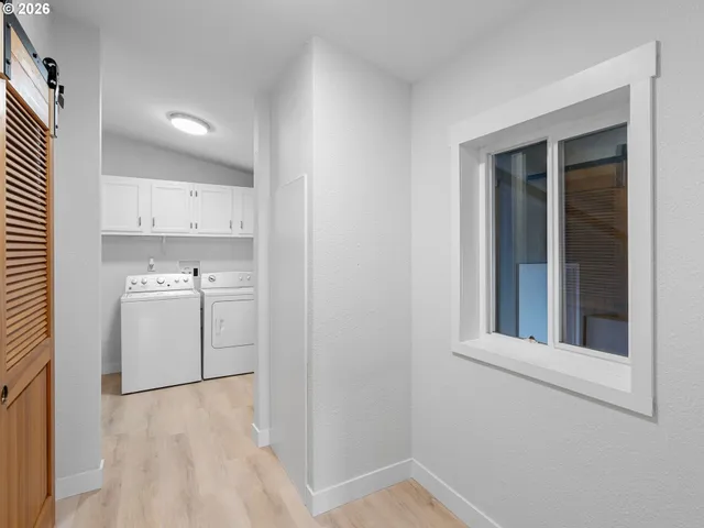 a view of a kitchen with white cabinets and sink