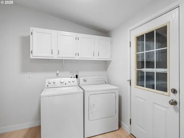 a view of storage and utility room with washer and dryer