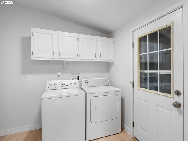 a view of storage and utility room with washer and dryer