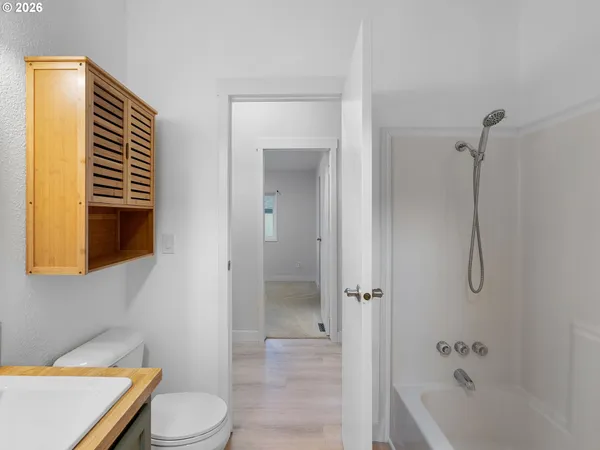 a bathroom with a toilet and a bathtub