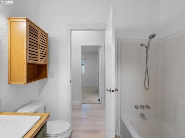 a bathroom with a toilet and a bathtub