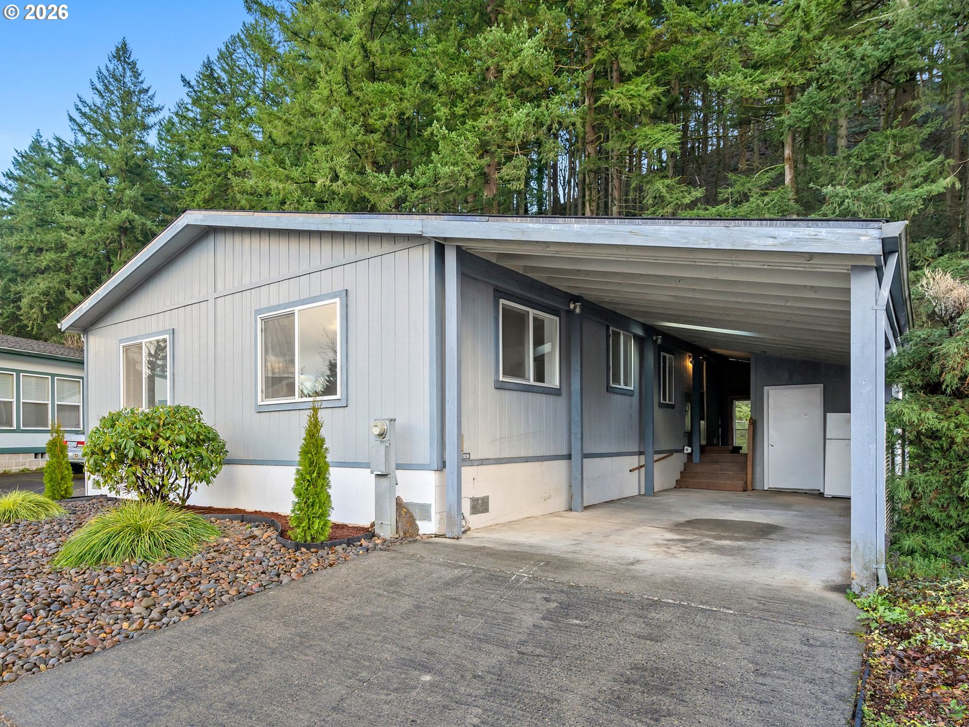 15768 Southeast Powell Boulevard, Unit 12 Portland, OR 97236 - Photo 2 of 31 a view of a house with a yard and plants